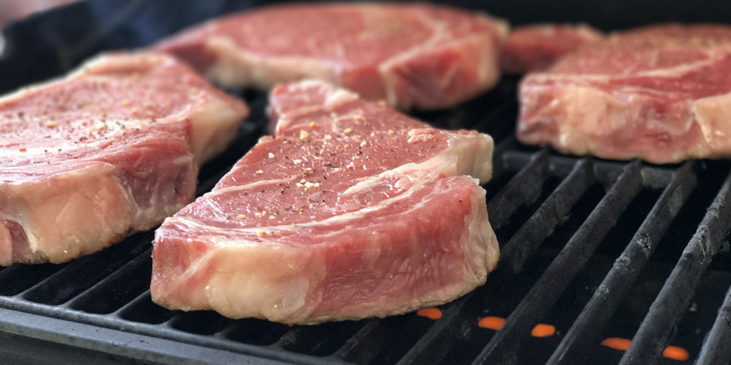 Beef steaks on grill